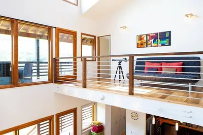 a room with a balcony with a couch and windows at Stone Ledge in Margaretville