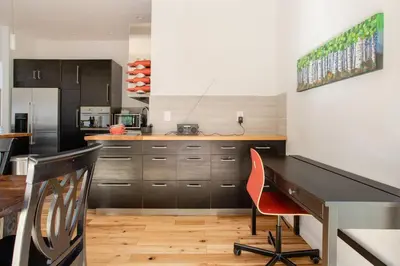 a kitchen with a desk and a kitchen with a refrigerator at Stone Ledge in Margaretville