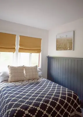 a bedroom with a blue and white bed with a window at 1 Mile to Hunter Mt! Cozy 3 Bedroom in Hunter