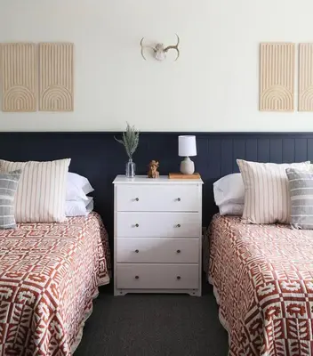 a bedroom with two beds and a white dresser at 1 Mile to Hunter Mt! Cozy 3 Bedroom in Hunter