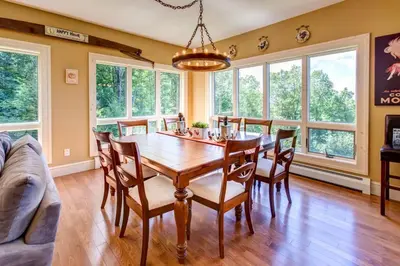 a dining room with a wooden table and chairs at Bovina Mountain High in Bovina Center