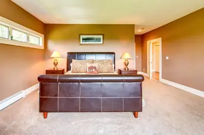 a large bedroom with a large bed and two lamps at Bovina Mountain High in Bovina Center