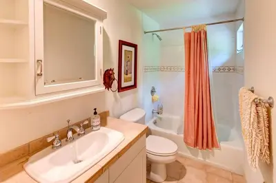 a bathroom with a sink and a toilet and a tub at Bovina Mountain High in Bovina Center
