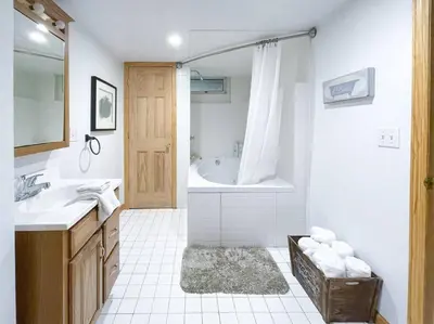 a bathroom with a tub and a sink and a shower at Birch Creek Lodge in Pine Hill