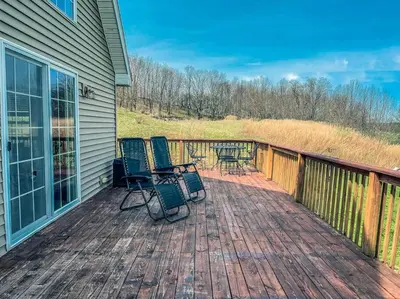 a deck with chairs and a table on it at Bluestone Hill House in Walton