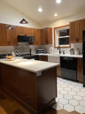 a kitchen with wooden cabinets and a white counter top at Hunter Mountain Sanctuary in Hunter
