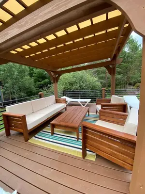 a patio with couches and tables on a deck at Hunter Mountain Sanctuary in Hunter