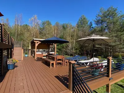 a wooden deck with tables and umbrellas at Hunter Mountain Sanctuary in Hunter