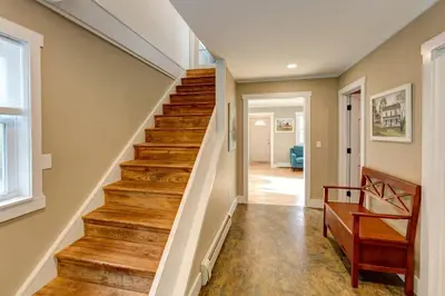 a staircase in a home with wood floors at The Heatherwood in Bovina Center