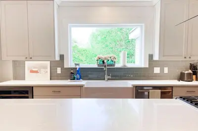 a white kitchen with a sink and a window at The Heatherwood in Bovina Center
