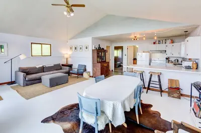 a kitchen and living room with a table and a couch at Hamden Hill House in Hamden