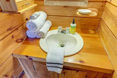 a bathroom with a sink in a tiny house at Rustic Roost Cabin in Vega
