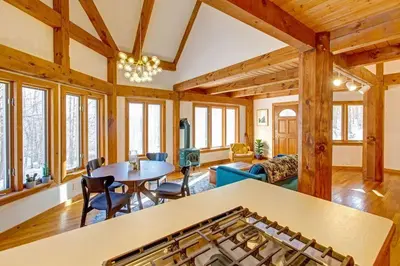 a large living room with a table and chairs at Catskills Enchanted Forest in Bloomville
