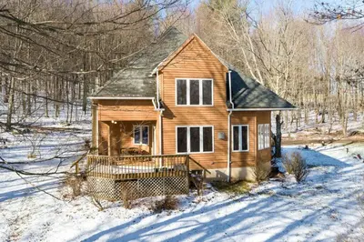 a wooden house in the snow in the woods at Catskills Enchanted Forest in Bloomville