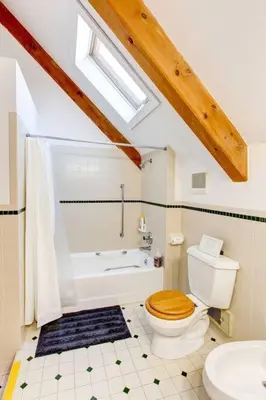 a bathroom with a toilet and a tub and a sink at Catskills Enchanted Forest in Bloomville