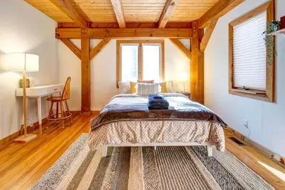 a bedroom with a bed in a room with wooden ceilings at Catskills Enchanted Forest in Bloomville