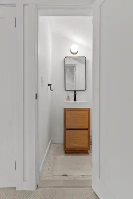 a bathroom with a sink and a mirror and a vanity at Elenas by the Mill in East Meredith