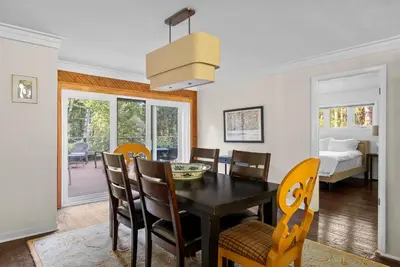a dining room with a black table and chairs at Elenas by the Mill in East Meredith