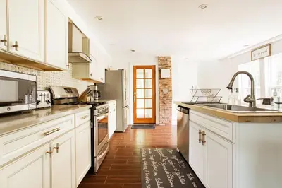 a kitchen with white cabinets and a sink at Cloud Crowd in Bloomville