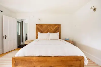 a bedroom with a large bed with a wooden headboard at Cloud Crowd in Bloomville