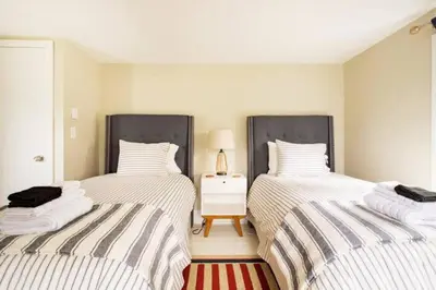 two twin beds in a room with a table at Cloud Crowd in Bloomville