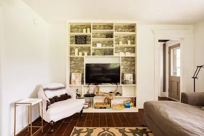 a living room with a chair and a television at Cloud Crowd in Bloomville