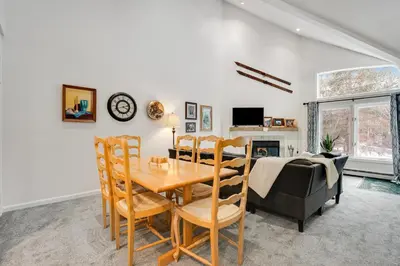 a dining room and living room with a table and chairs at Skiing Haven in Dover