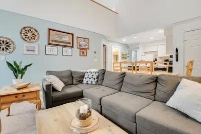 a living room with a gray couch and a table at Skiing Haven in Dover