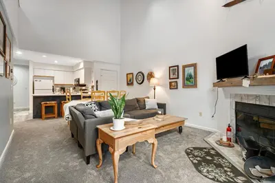 a living room with a couch and a fireplace at Skiing Haven in Dover