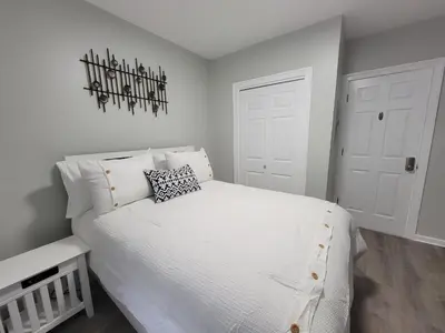 a bedroom with a large white bed with white pillows at One room for rent shared bathroom and kitchen in Hartford
