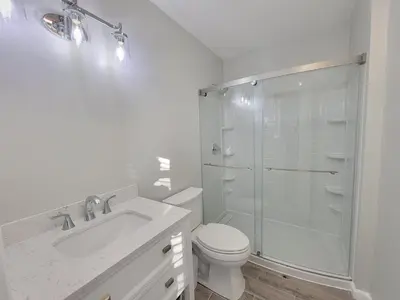 a bathroom with a shower and a toilet and a sink at One room for rent shared bathroom and kitchen in Hartford