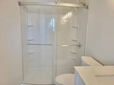 a shower with a glass door in a bathroom at One room for rent shared bathroom and kitchen in Hartford