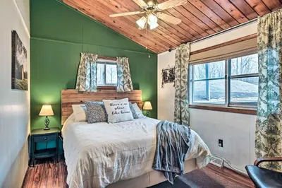 a green bedroom with a bed and a ceiling fan at Cozy Catskills Escape, 3 Mi to Plattekill Mtn in Roxbury