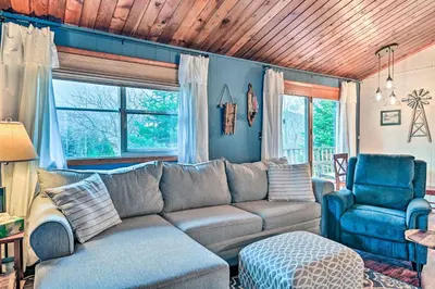 a living room with a couch and a chair at Cozy Catskills Escape, 3 Mi to Plattekill Mtn in Roxbury