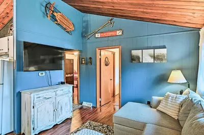 a living room with blue walls and a couch at Cozy Catskills Escape, 3 Mi to Plattekill Mtn in Roxbury