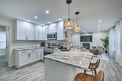 a kitchen with white cabinets and a large island at Community Beach and Lake Pocono Summit Escape in Pocono Summit