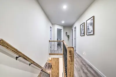 a staircase in a house with white walls and wooden floors at Community Beach and Lake Pocono Summit Escape in Pocono Summit