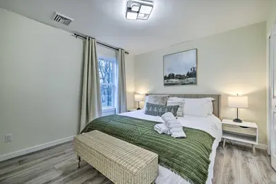 a bedroom with a large bed and a window at Community Beach and Lake Pocono Summit Escape in Pocono Summit