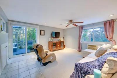 a living room with a couch and a chair at Cozy Dix Hills Apt with Deck about 7 Mi to Beach! in Dix Hills