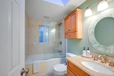 a bathroom with a tub and a toilet and a sink at Cozy Dix Hills Apt with Deck about 7 Mi to Beach! in Dix Hills