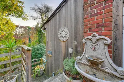 a wooden fence with a sink next to a building at Cozy Dix Hills Apt with Deck about 7 Mi to Beach! in Dix Hills
