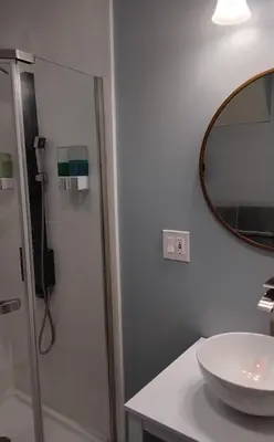 a bathroom with a sink and a shower with a mirror at Heavenly Home in New Haven in New Haven
