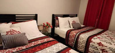 two beds sitting next to each other in a room at Heavenly Home in New Haven in New Haven