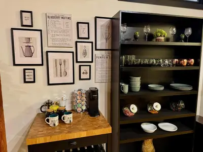 a kitchen with a table with a coffee maker on a shelf at Brick City Loft in Newark