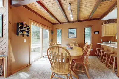 a dining room with a wooden table and chairs at Suntec Getaway in Dover