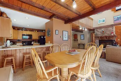 a kitchen and dining room with a wooden table and chairs at Suntec Getaway in Dover