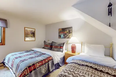 two beds in a small room with white walls at Suntec Getaway in Dover