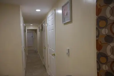 a hallway with white walls and a hallway with white doors at Mamas Love 2bedroom Spacious Apartment in Newark