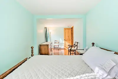 a bedroom with a white bed and a table and chairs at Cozy Tannersville Gem - Ski, Hike, Explore! in Tannersville