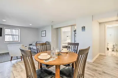 a dining room and living room with a wooden table and chairs at Charming Beacon Apt with Fire Pit Near Hiking! in Beacon